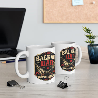 White ceramic mug with "BALKAN DAD BUILT DIFFERENT" text and graphic.