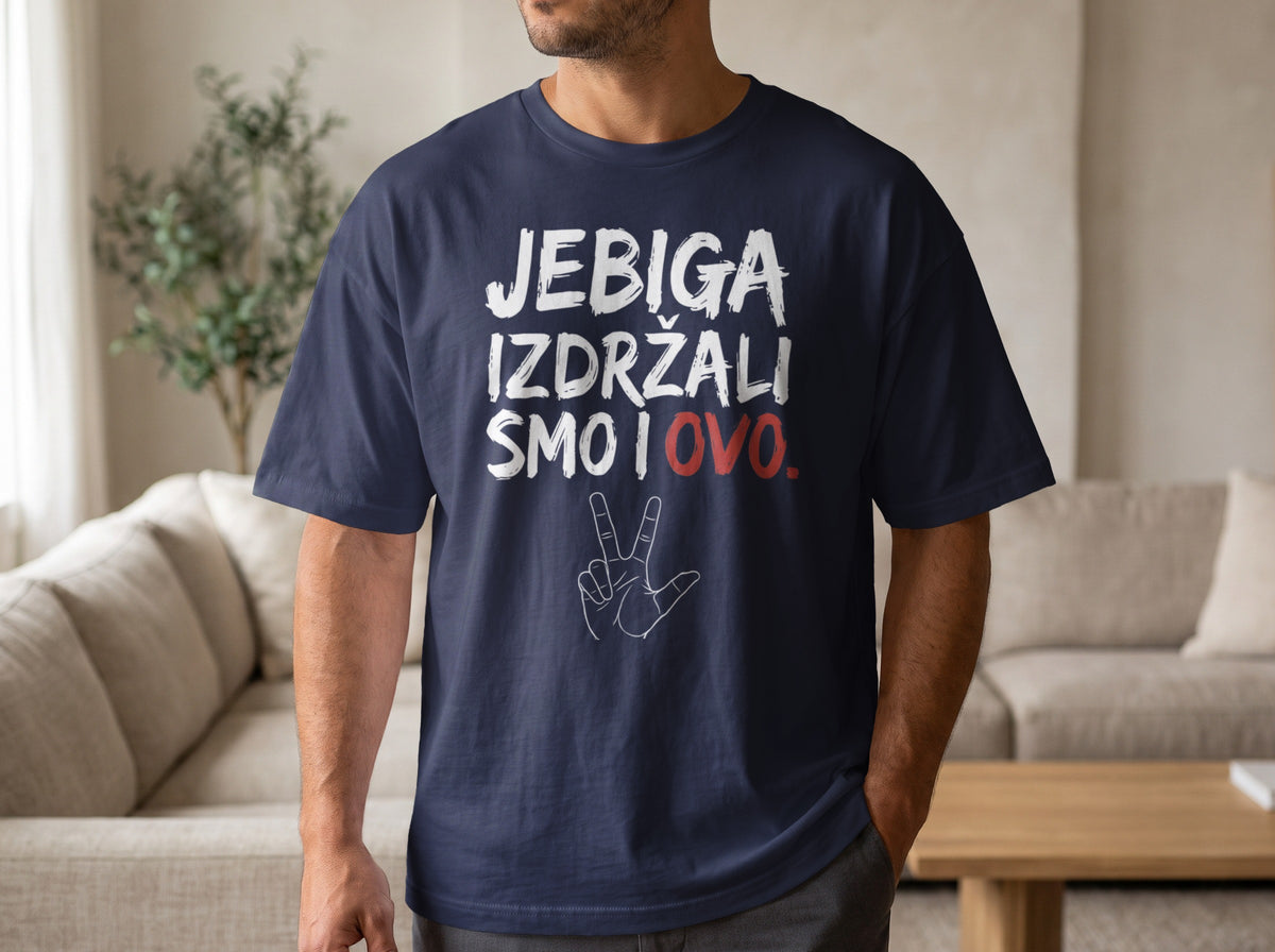 A man wearing a dark blue t-shirt printed with white text reading JEBIGA IZDRŽALI SMO I OVO and a hand graphic.