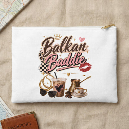 White makeup bag with "Balkan Baddie" text, coffee cup, and accessories.