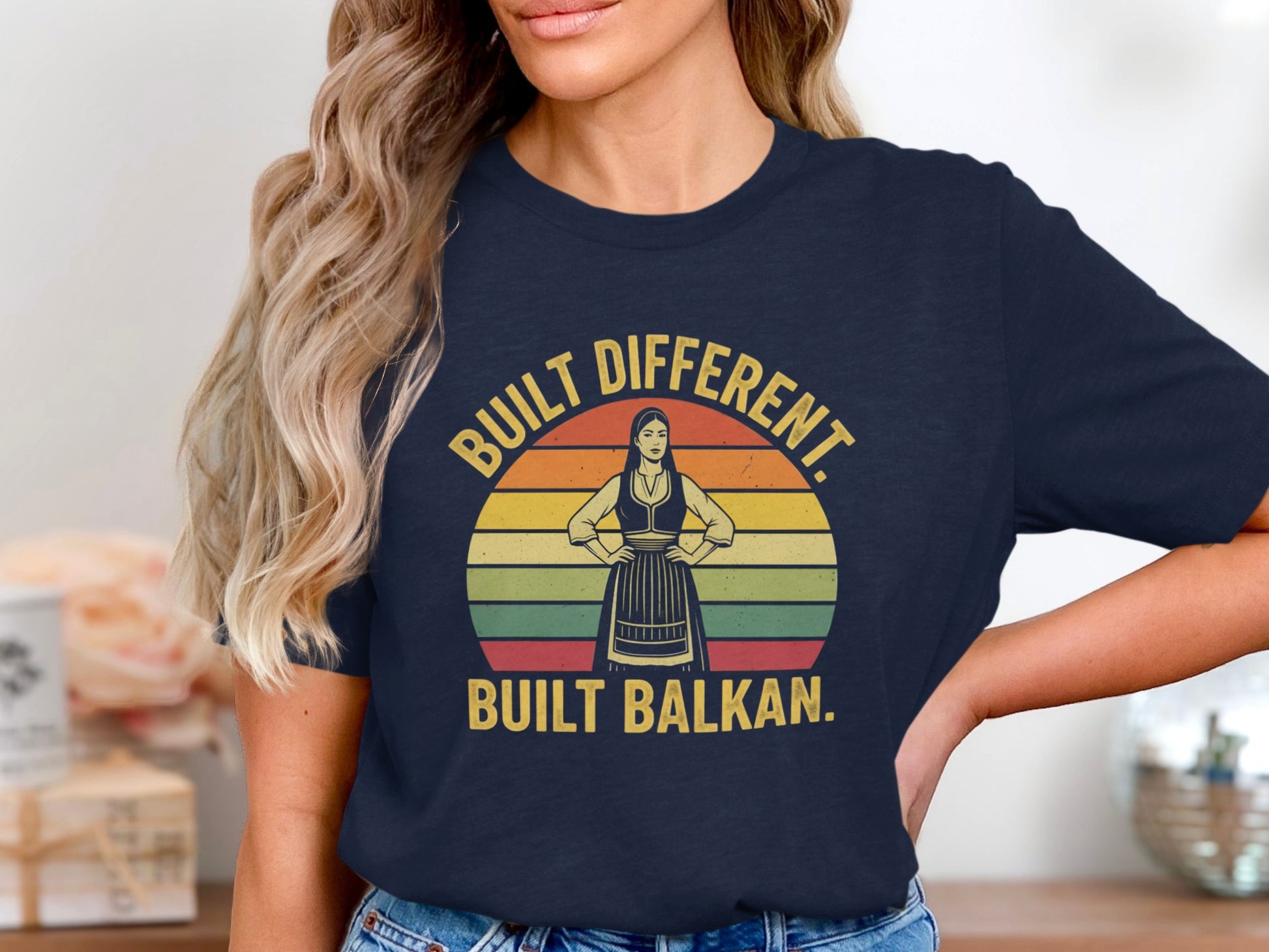 Navy t-shirt with "Built Different. Built Balkan." text and vintage sunset graphic.
