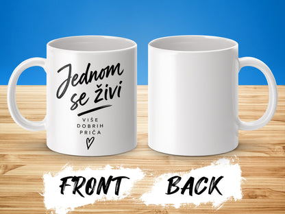White mug with "Jednom se živi" text and a heart.
