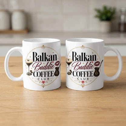 White mugs with "Balkan Baddie Coffee Club" logo featuring coffee cups.