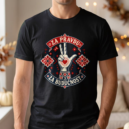 A person wearing a black t-shirt with a graphic design featuring a hand making a three-finger salute, traditional red and blue embroidery patterns, and the text ZA PRAVDU ZA BUDUCNOST.