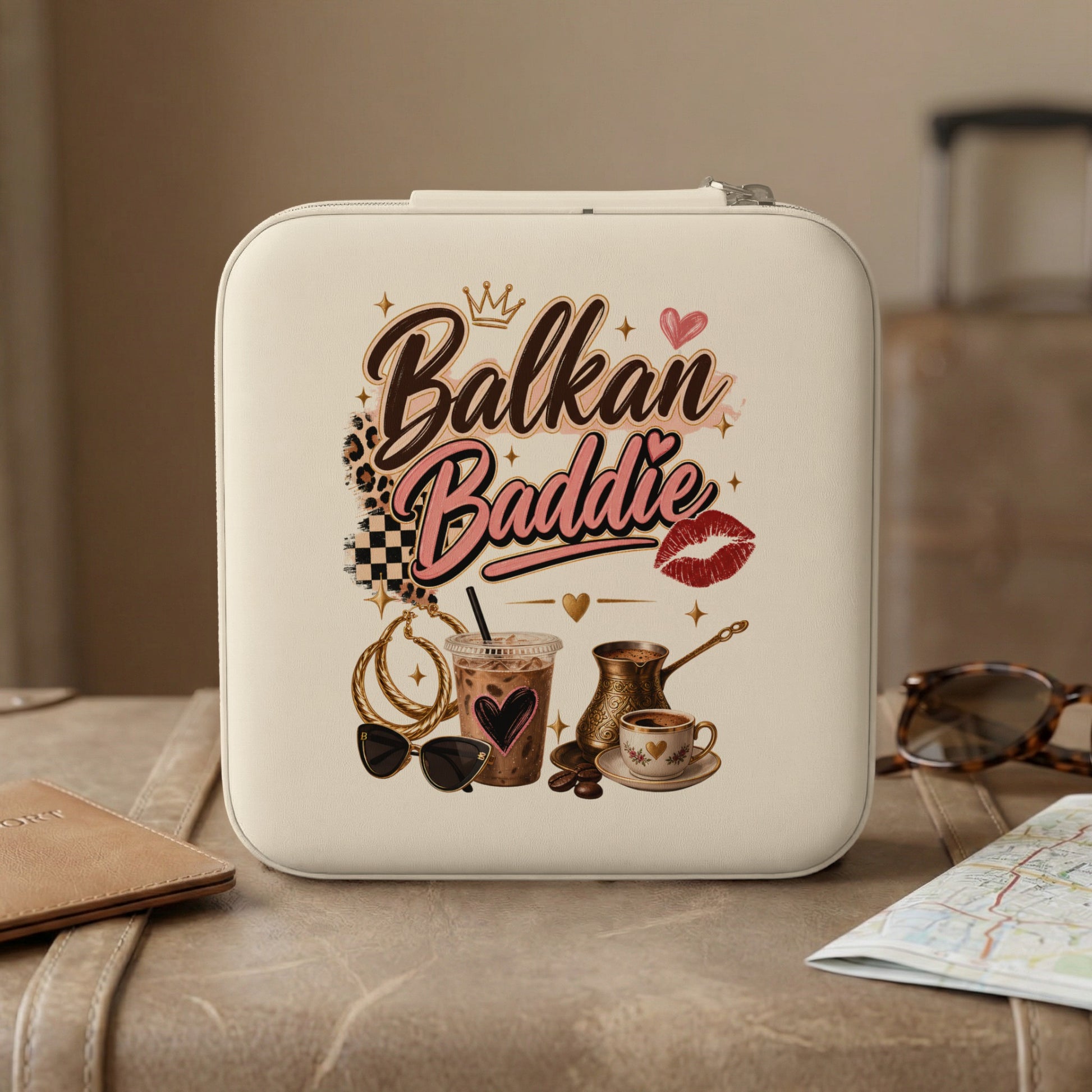 White travel case with "Balkan Baddie" text, coffee, and accessories.