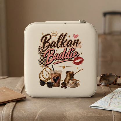 White travel case with "Balkan Baddie" text, coffee, and accessories.