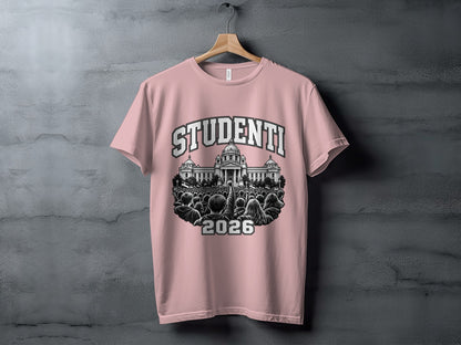A pink t-shirt hanging on a textured wall features a graphic of a crowd with the text "STUDENTI 2026."