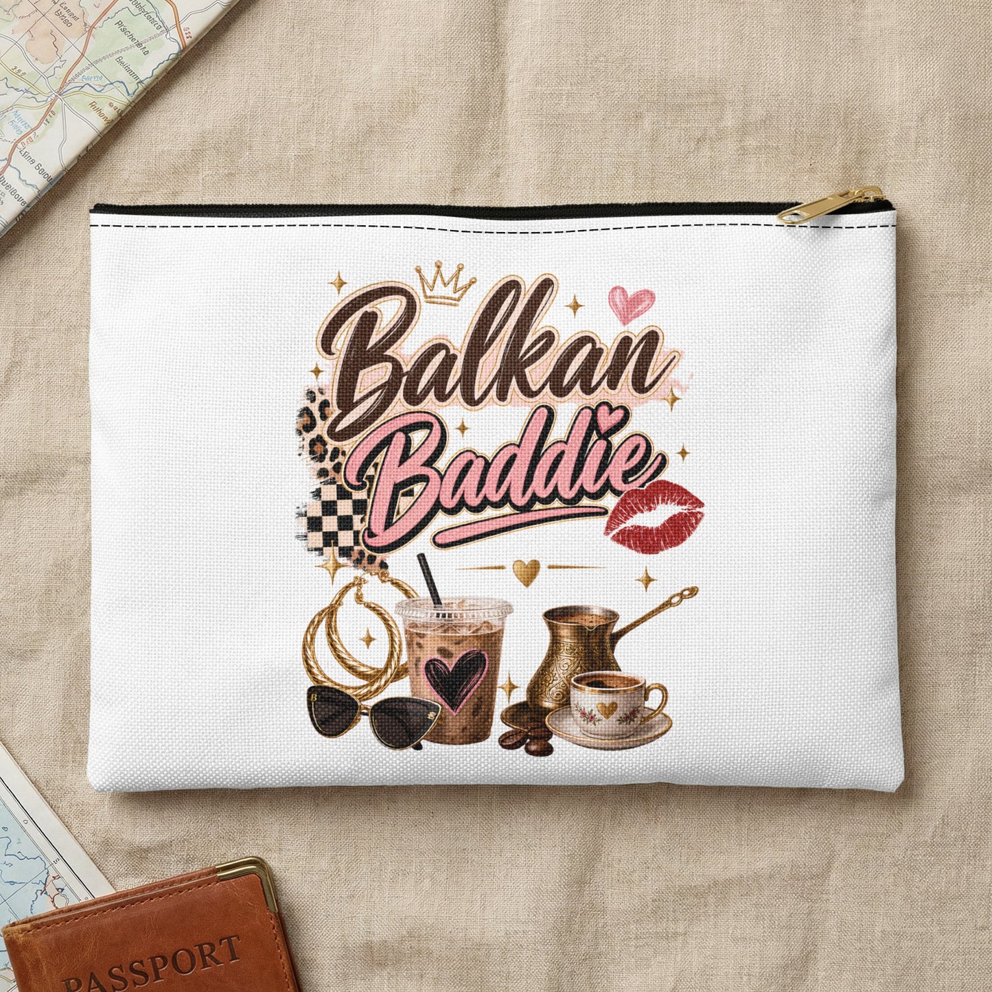 White pouch with "Balkan Baddie" text, coffee, sunglasses, and jewelry.