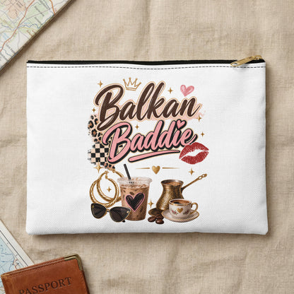 White pouch with "Balkan Baddie" text, coffee, sunglasses, and jewelry.