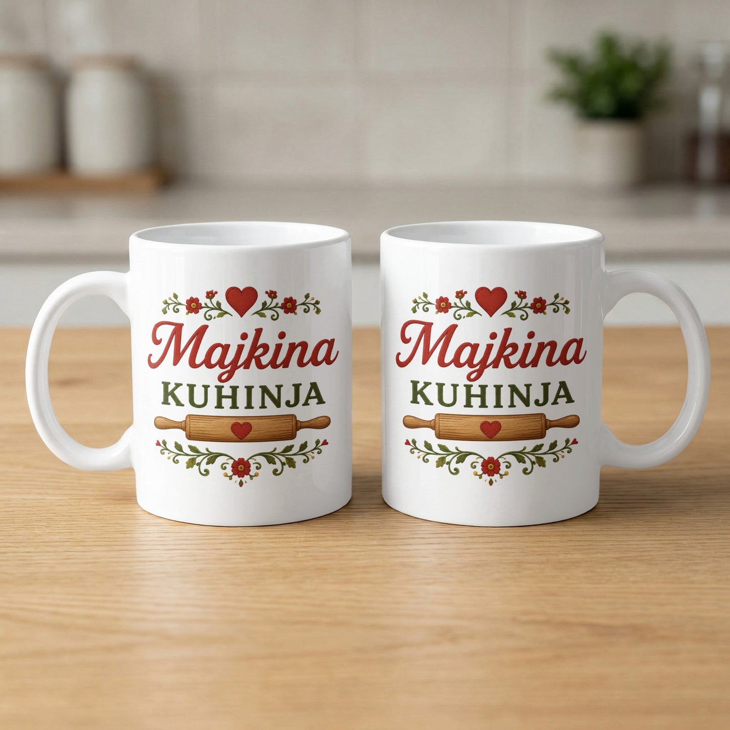 Two white mugs with "Majkina Kuhinja" in red and green text with rolling pin graphic.