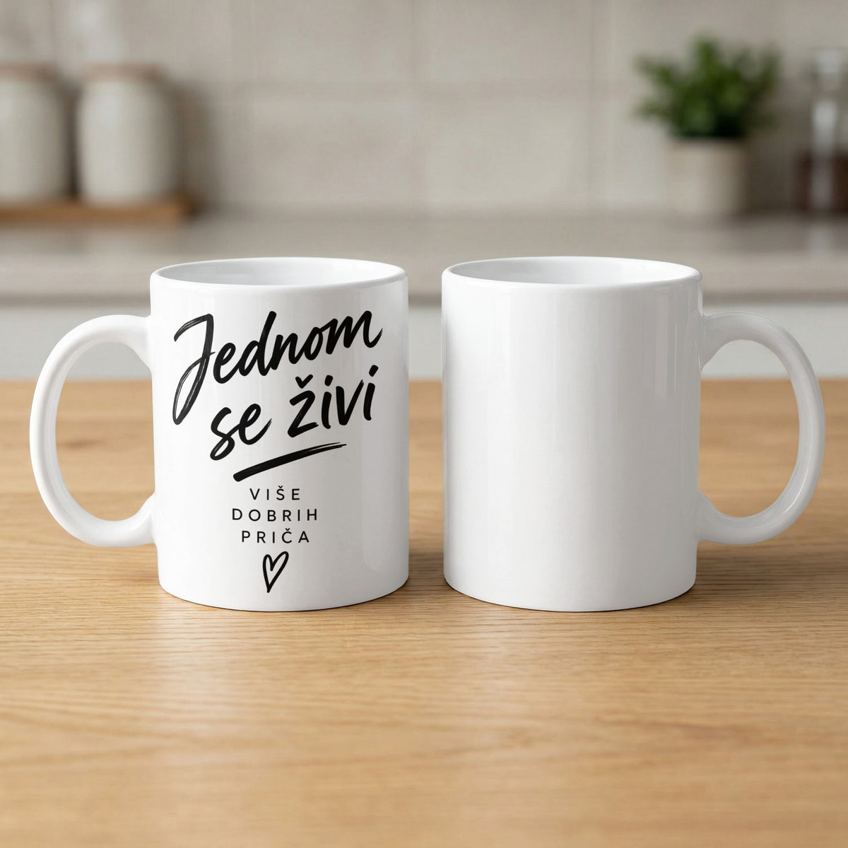 White mug with text "Jednom se živi" and "VIŠE DOBRIH PRIČA" and a heart.