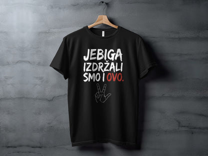 Black t-shirt hanging on a wooden hanger, featuring white and red printed text with a hand symbol.