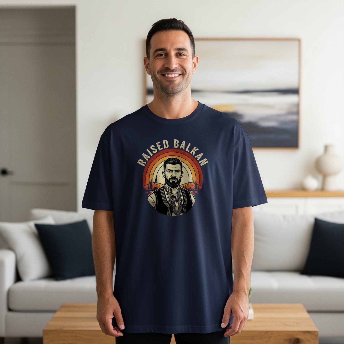 Navy t-shirt with a circular vintage design featuring a man and text "RAISED BALKAN".
