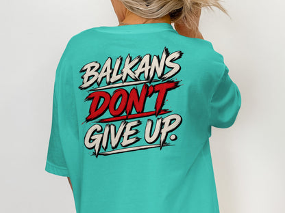 Turquoise t-shirt with "Balkans Don't Give Up" text design on back.