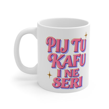 White mug with pink text that reads "PIJ TU KAFU I NE SERI".