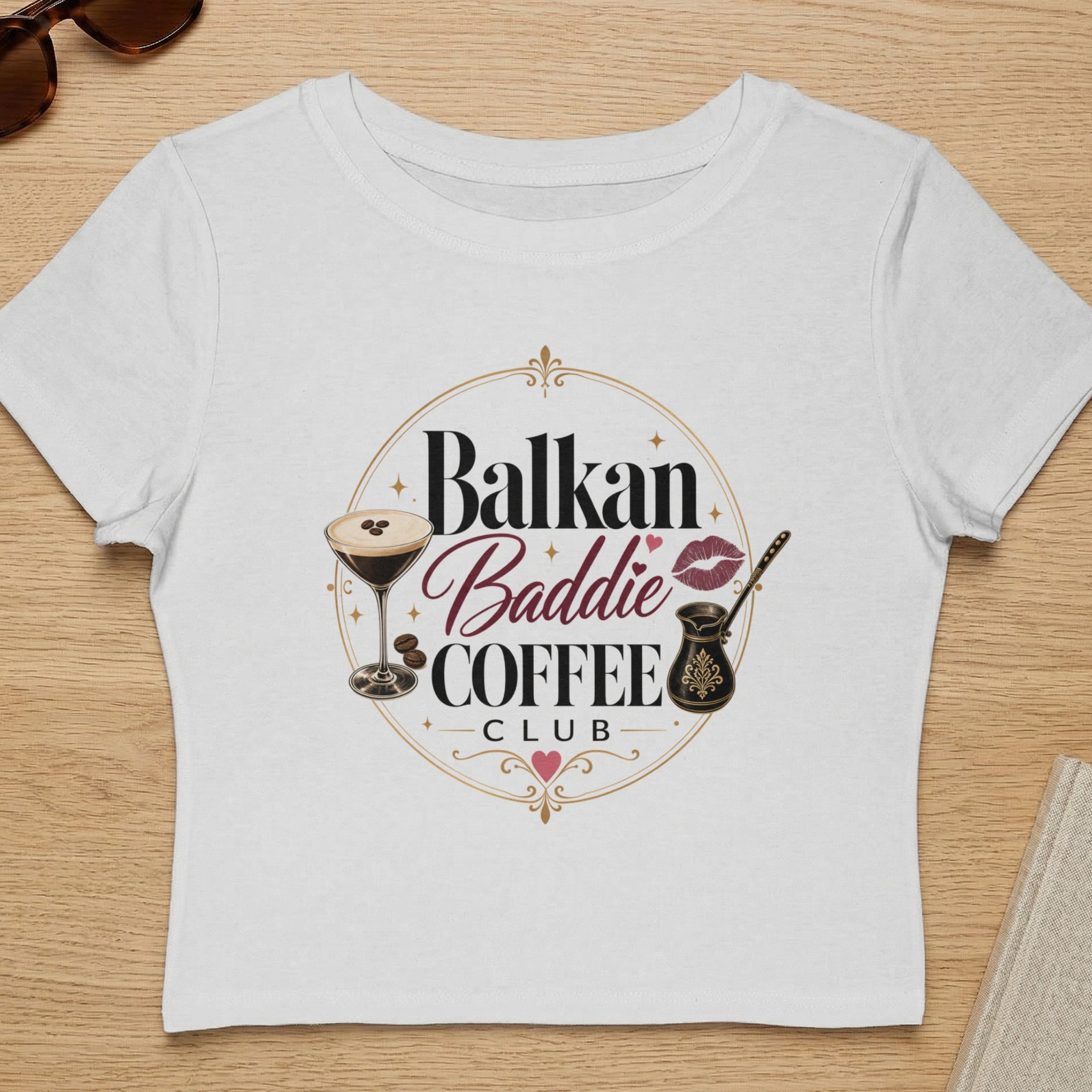 White t-shirt with "Balkan Baddie Coffee Club" text and graphics.