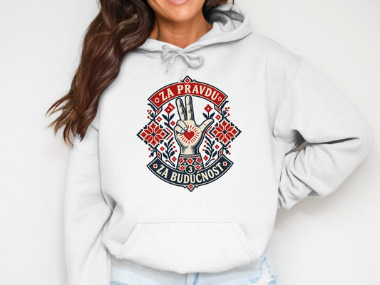 A person wearing a white hooded sweatshirt with a decorative red and blue graphic displaying the text Za Pravdu Za Buducnost.