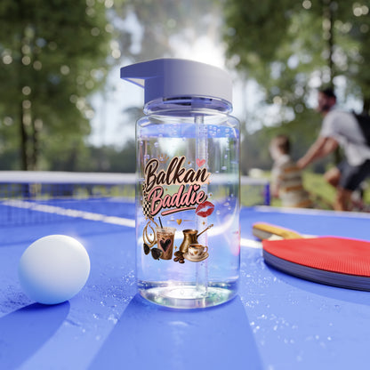 Clear water bottle with "Balkan Baddie" text and graphics on a ping pong table.