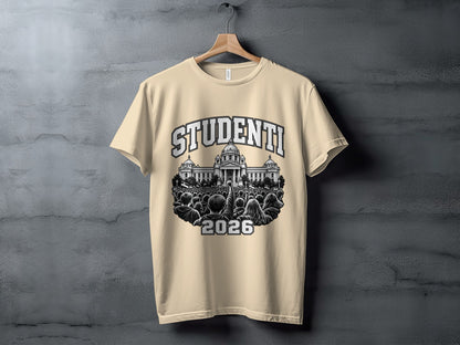 A cream-colored t-shirt hanging on a wooden hanger against a textured gray background, featuring a graphic illustration of a crowd protesting in front of a government building with the text "STUDENTI 2026."