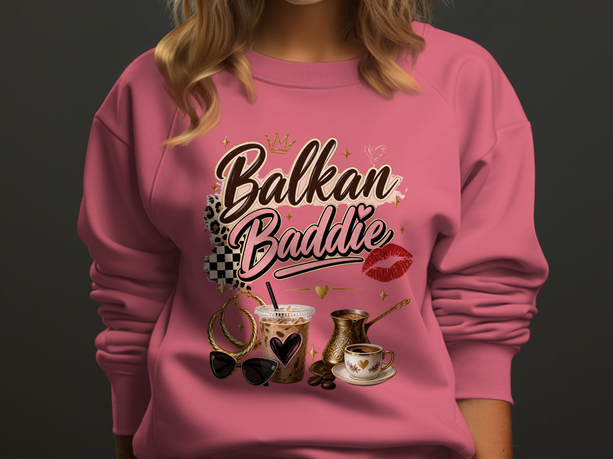 Pink sweatshirt with "Balkan Baddie" text, coffee, and accessories design.
