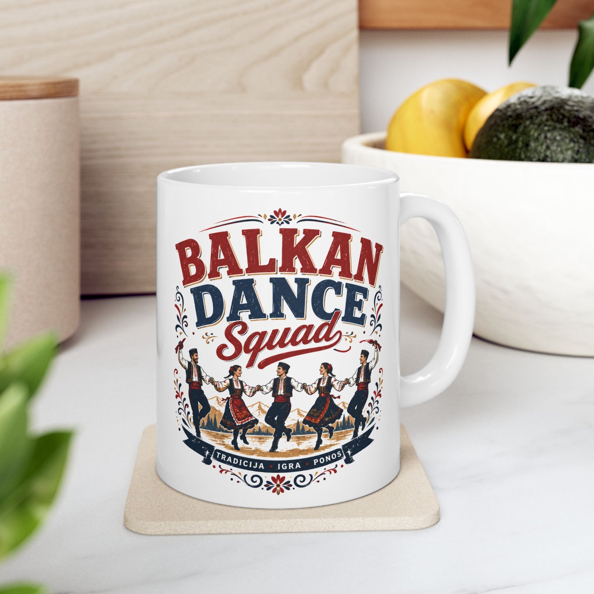 White mug with "Balkan Dance Squad" text and people in traditional dance attire.