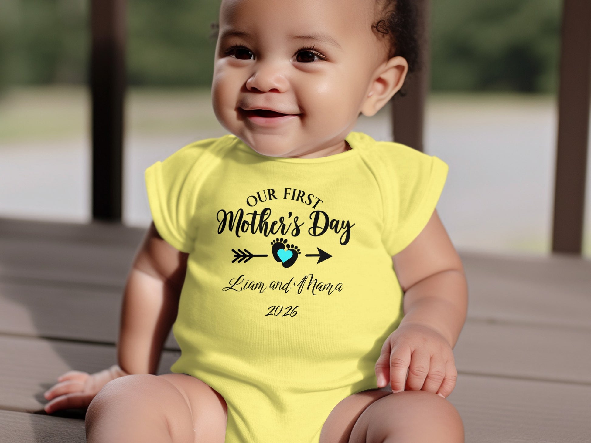 Yellow baby onesie with "Our First Mother's Day" and "Liam and Mama 2025".