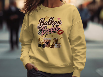 Yellow sweatshirt with "Balkan Baddie" text, iced coffee, coffee pot, and sunglasses.