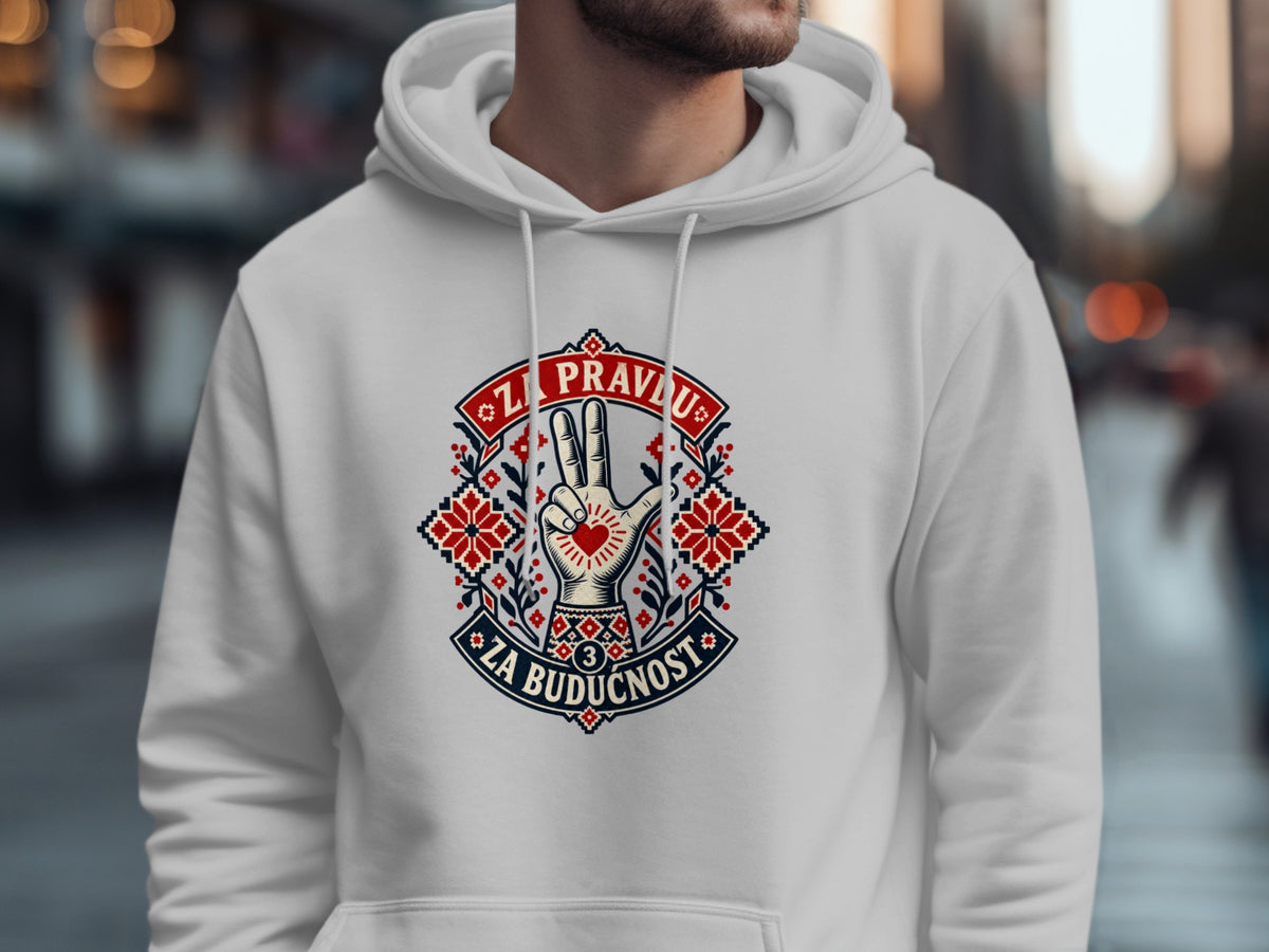 A person wears a white hooded sweatshirt with a decorative red, white, and black graphic featuring text and a hand symbol.