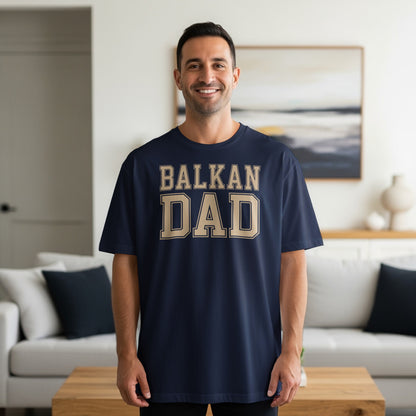 Man wearing navy t-shirt with "BALKAN DAD" in gold text.