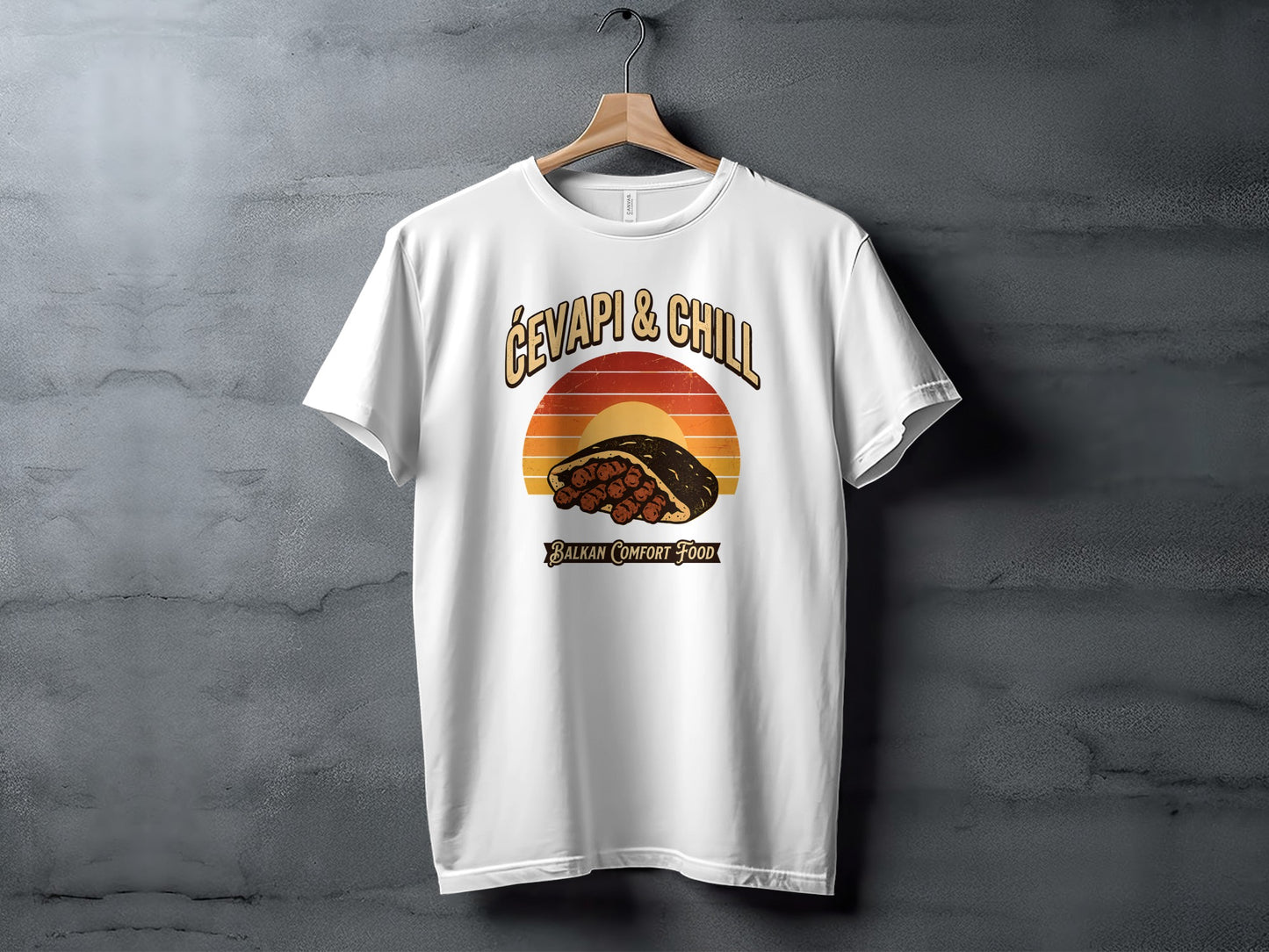 White t-shirt with "Ćevapi & Chill Balkan Comfort Food" graphic featuring a sandwich and sunset.