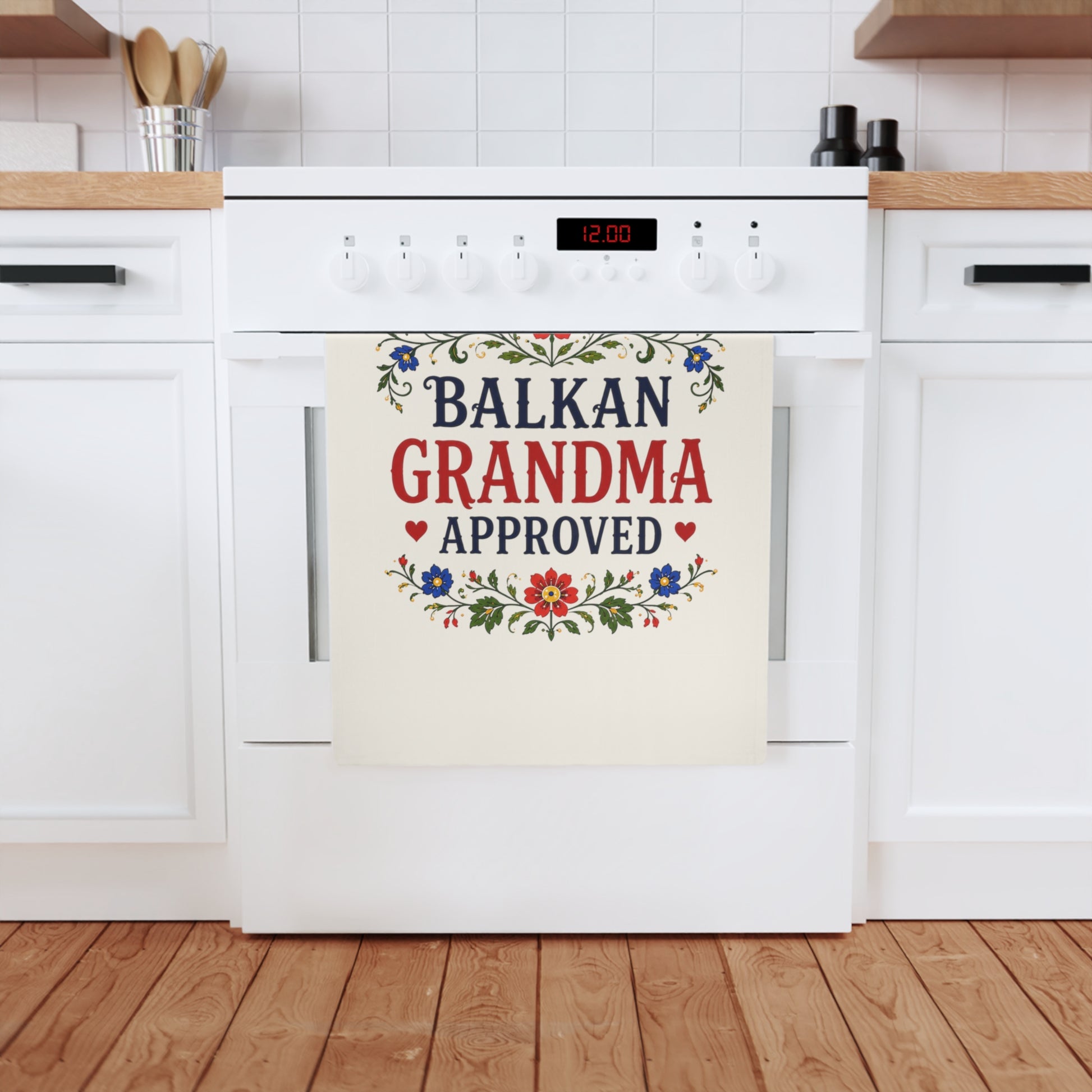 Tea towel with "Balkan Grandma Approved" in red and blue floral border.