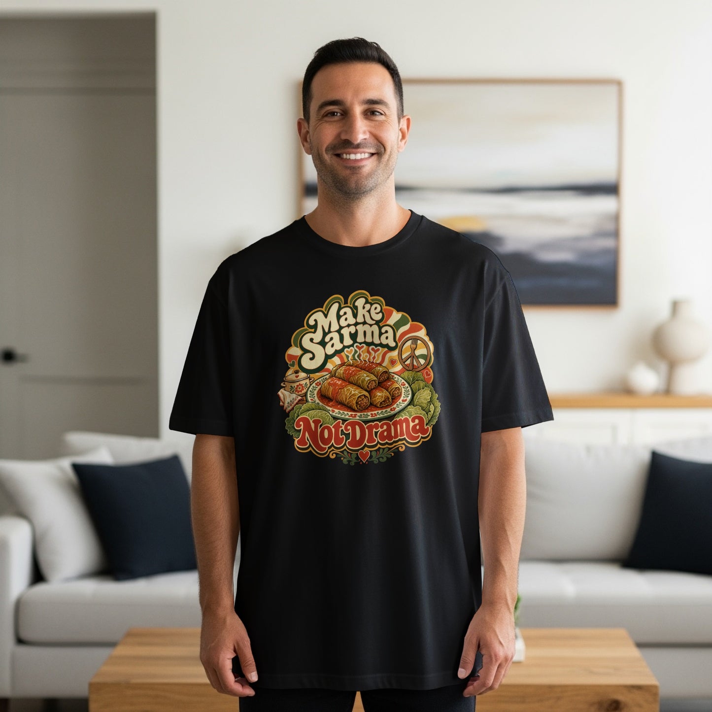 Man wearing black t-shirt with colorful "Make Sarma" graphic featuring food.