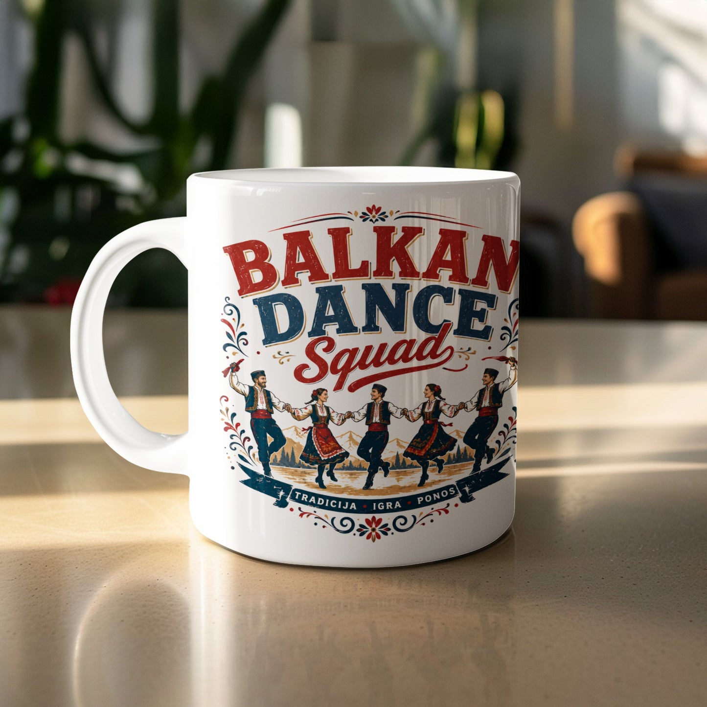 White mug with "Balkan Dance Squad" and traditional dancers and scenery.