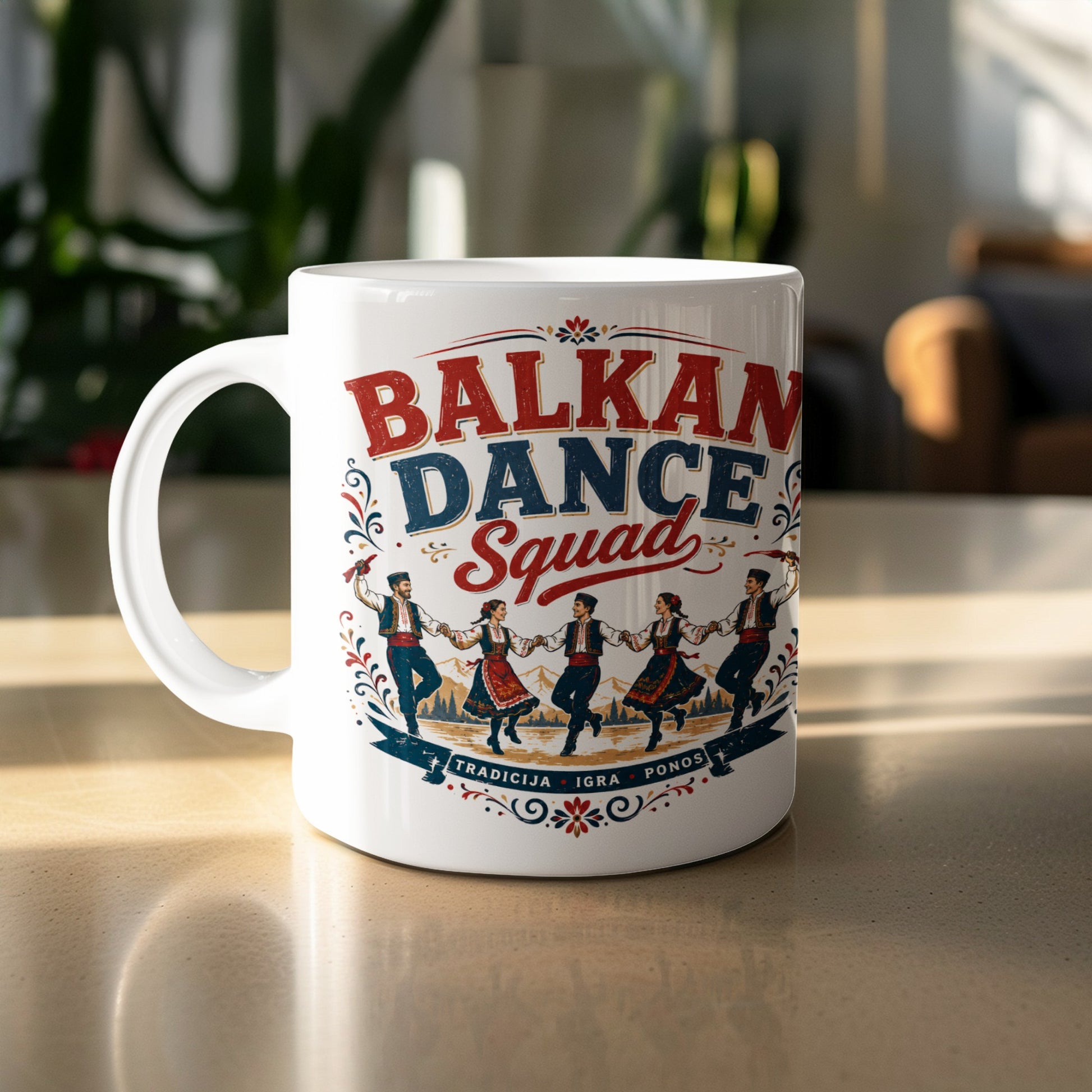 White mug with "Balkan Dance Squad" and traditional dancers and scenery.
