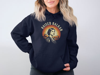 Navy hoodie with "RAISED BALKAN" text and a portrait of a woman.