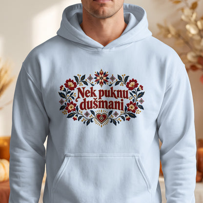 A person wearing a light blue hooded sweatshirt featuring an embroidered floral wreath and the text Nek puknu dušmani in red.