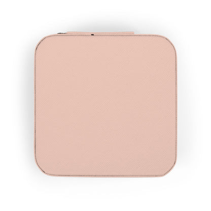 Closed peach textured square case with zipper detail on white background.