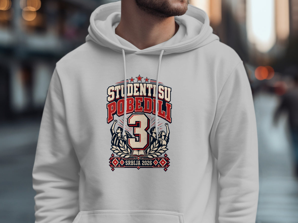 A person wearing a white hoodie featuring a red and blue graphic with the text "STUDENTI SU POBEDILI 3 SRBIJA 2026."
