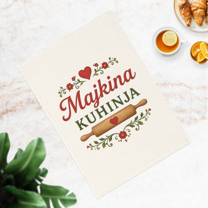 Decorative tea towel with "Majkina KUHINJA" text, rolling pin, and floral accents.