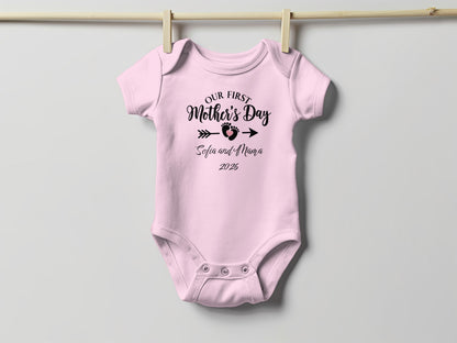 Pink baby onesie with "Our First Mother's Day Sofia and Mama 2026" text.