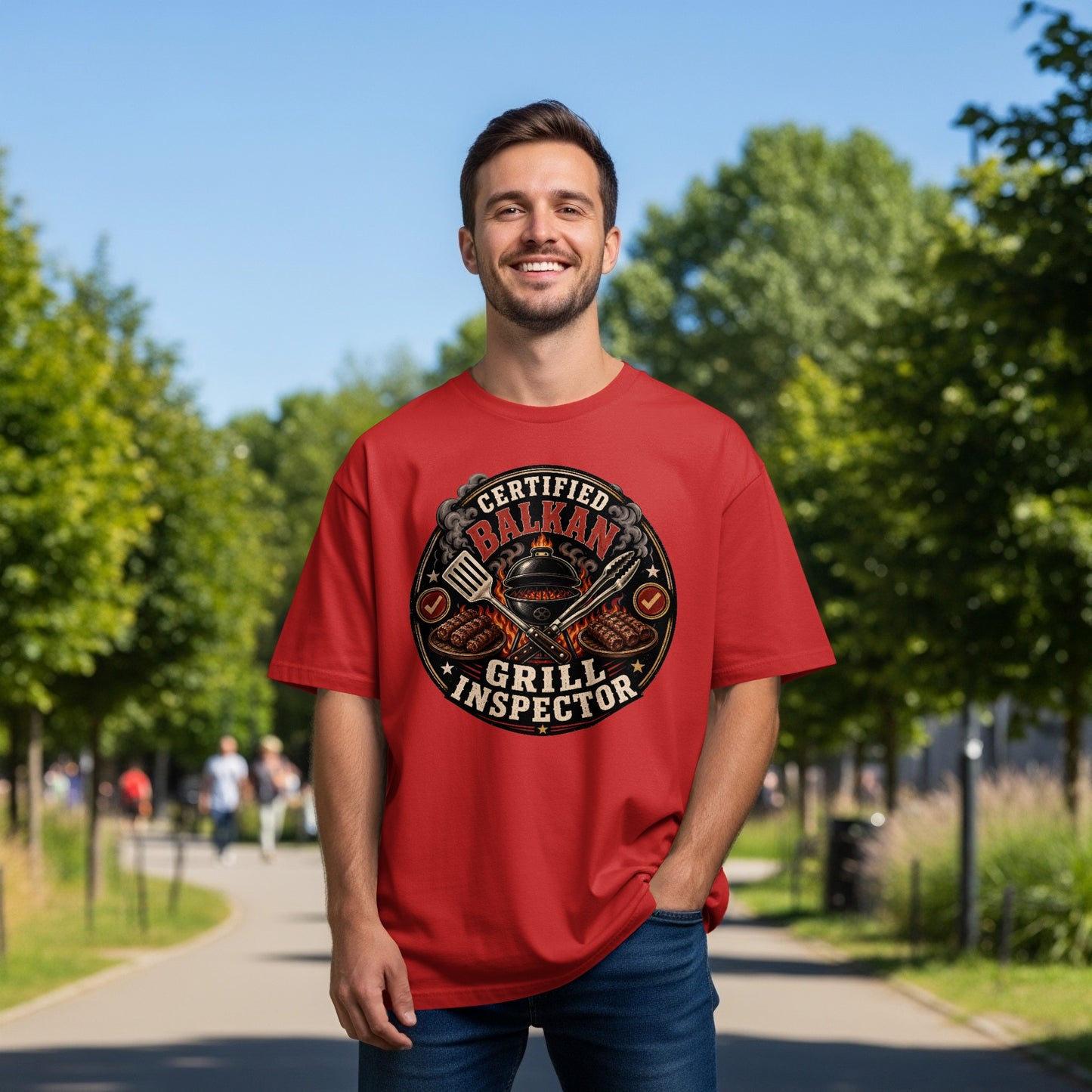 Red t-shirt with "Certified Balkan Grill Inspector" text and grilling tools graphic.