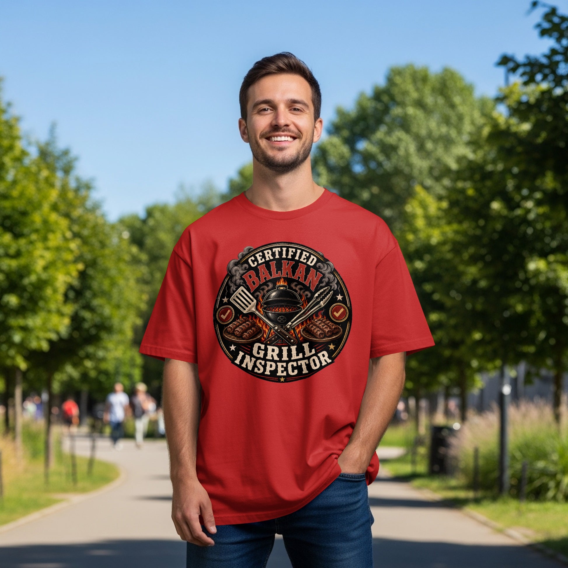 Red t-shirt with "Certified Balkan Grill Inspector" text and grilling tools graphic.