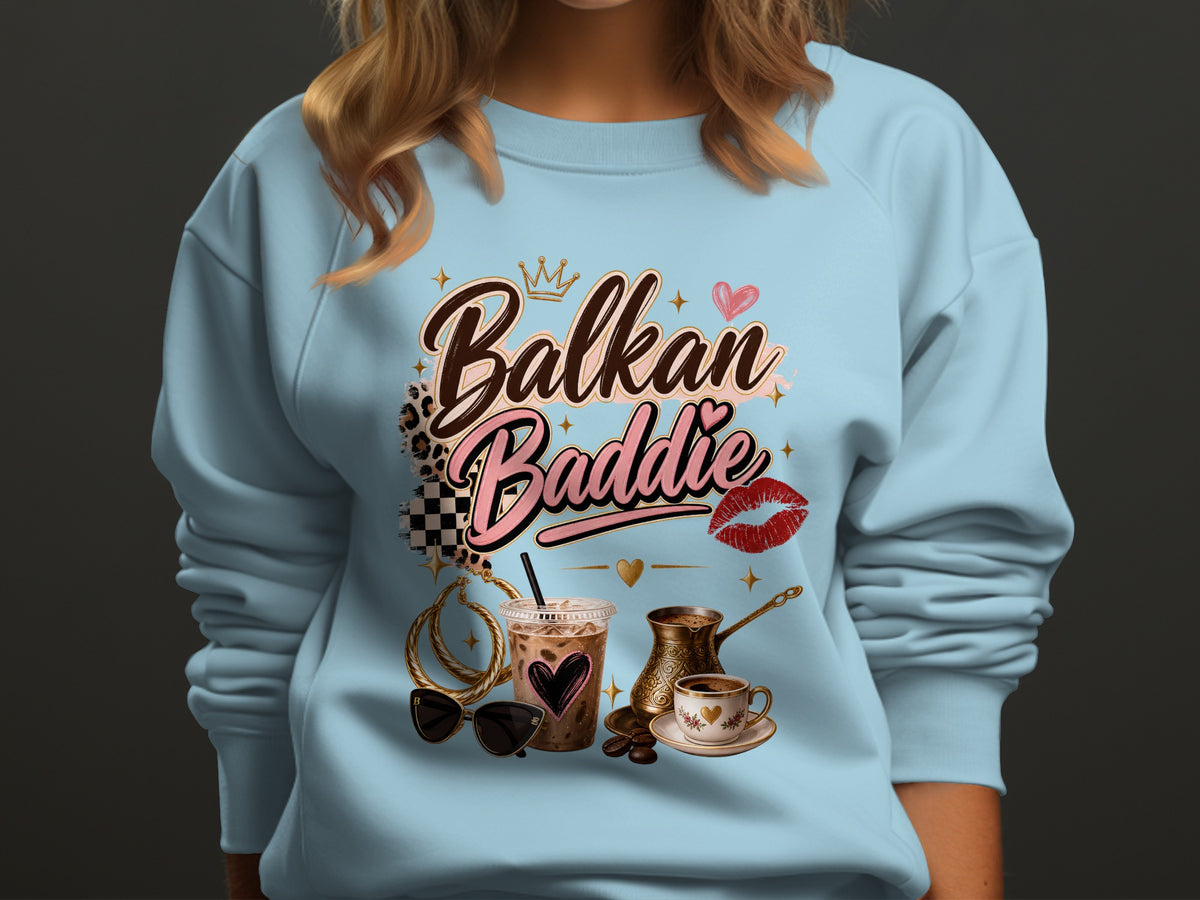 Light blue sweatshirt with "Balkan Baddie" text, coffee, and accessories design.