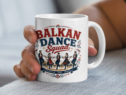 White mug with "BALKAN DANCE SQUAD" and folkloric dancers illustration.