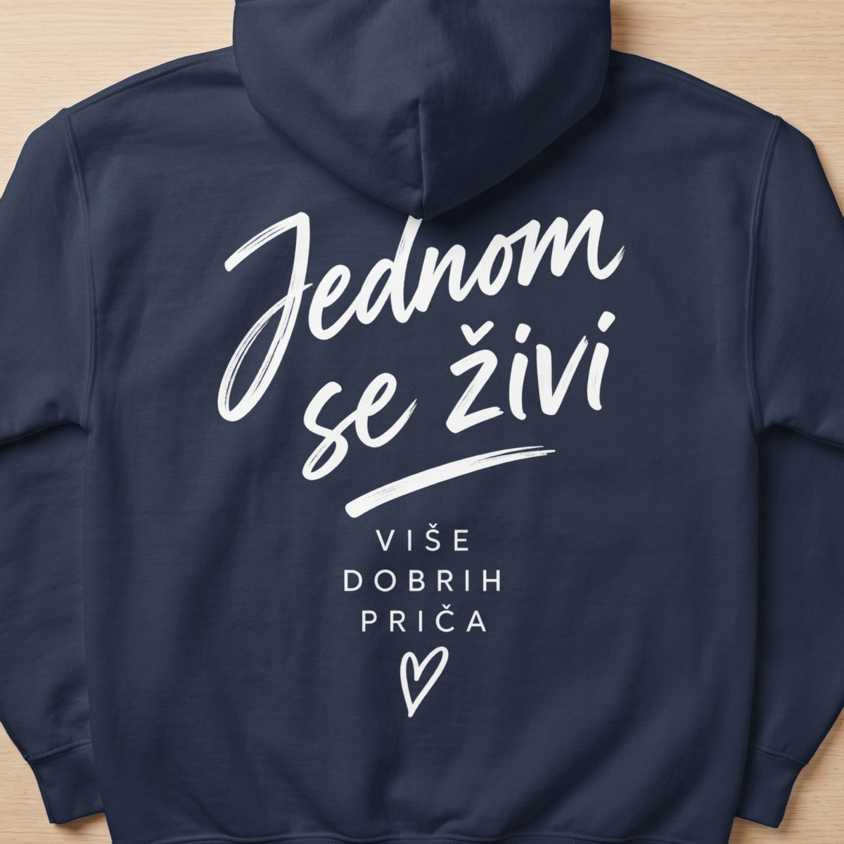 Navy blue hoodie with white text "Jednom se živi" and "Više dobrih priča" with a heart.