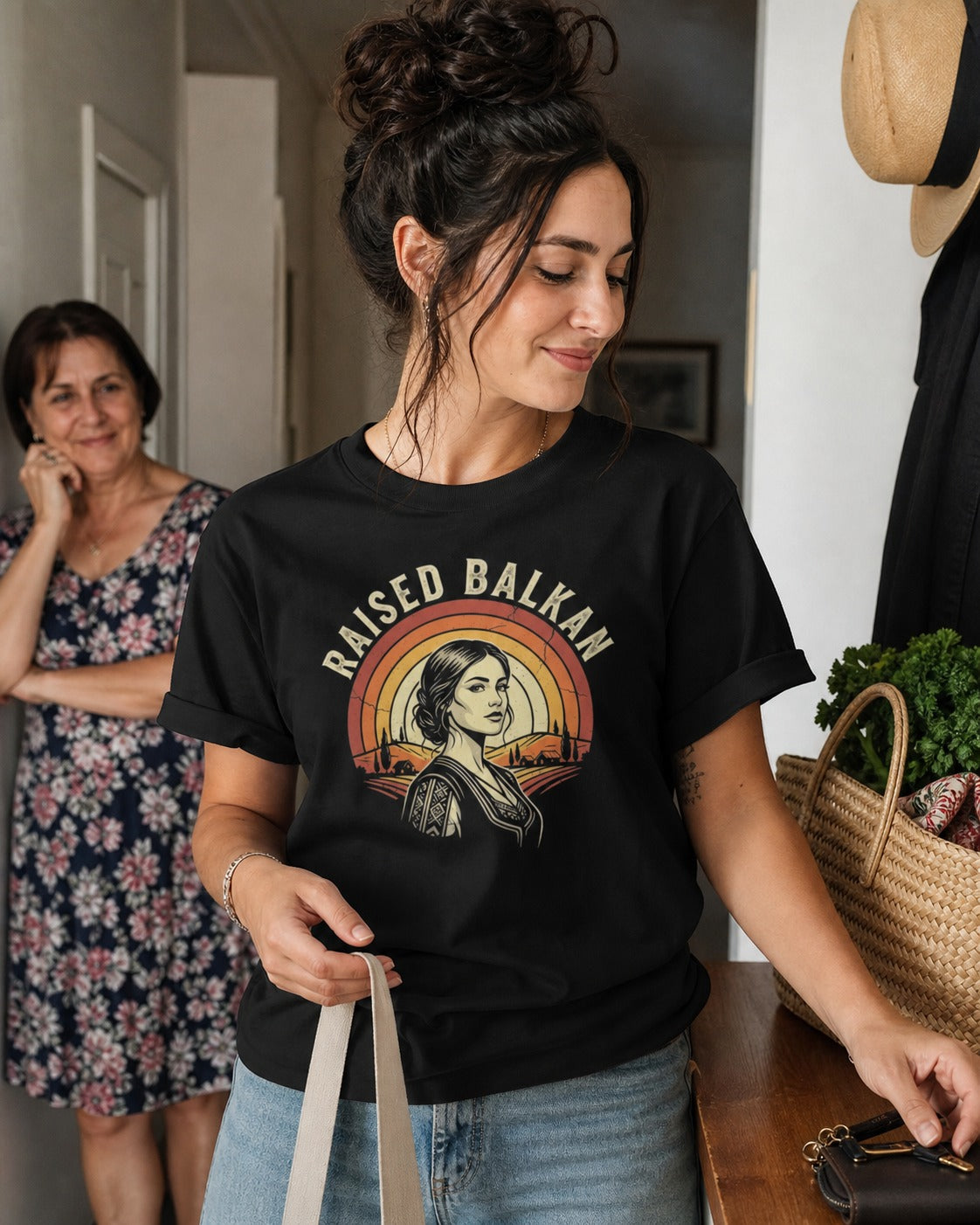 Woman wearing a black Raised Balkan T-shirt with a family member